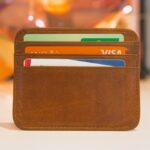 A brown leather wallet holding several credit and bank cards is displayed upright on a white surface—perfect for showcasing your small business SEO products in Corona, CA.